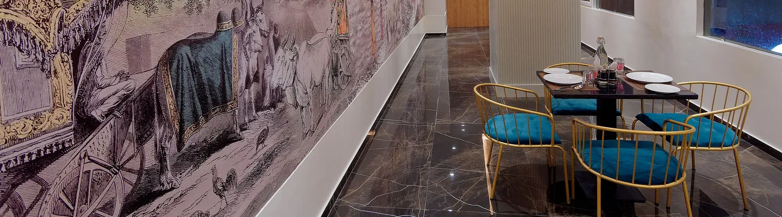 Image of seating area with chairs and tables and mural on the wall at Ankit Hotel, Jabalpur