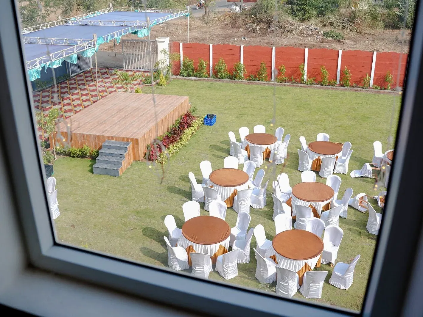 Seating and stage arrangement in the garden area of ANS M Square Hotel & Resort, Kalaburagi